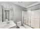 Well-lit bathroom featuring a vanity sink and tiled shower and glass door at 402 Leslie Ct, Mcdonough, GA 30253