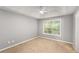 Bright bedroom with a ceiling fan, neutral walls, and a large window for natural light at 402 Leslie Ct, Mcdonough, GA 30253
