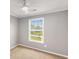 Bedroom with plush carpet, neutral paint, large window and a ceiling fan at 402 Leslie Ct, Mcdonough, GA 30253