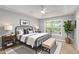 Inviting bedroom with a ceiling fan, a window, stylish furniture and decor at 402 Leslie Ct, Mcdonough, GA 30253