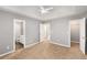 Spacious bedroom with tray ceilings and neutral carpet leading to bathroom and closet at 402 Leslie Ct, Mcdonough, GA 30253