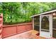 View of stained wood deck and screened in porch at 402 Leslie Ct, Mcdonough, GA 30253