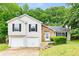 Charming home featuring a two-car garage, stone accents, neutral siding and nicely landscaped yard at 402 Leslie Ct, Mcdonough, GA 30253