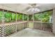 Spacious screened porch with views of the backyard greenery and lattice railing at 402 Leslie Ct, Mcdonough, GA 30253