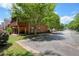 Charming back exterior of a brick townhome featuring a covered porch and lush landscaping at 4201 Village Green Dr, Roswell, GA 30075