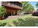 Lush backyard with brick home, featuring a covered porch, perfect for relaxation and entertaining at 4201 Village Green Dr, Roswell, GA 30075