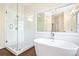 Bright bathroom featuring glass enclosed shower and white tile backsplash at 4201 Village Green Dr, Roswell, GA 30075