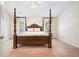 Bedroom featuring a four-poster bed, neutral walls, carpet, and bright light at 4201 Village Green Dr, Roswell, GA 30075