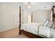Bedroom featuring a four-poster bed, neutral walls, carpet, and chandelier at 4201 Village Green Dr, Roswell, GA 30075