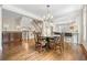 Open-concept dining area adjacent to the kitchen showcases hardwood floors, a staircase, and elegant details at 4201 Village Green Dr, Roswell, GA 30075