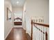 Hallway has hardwood floors and view into a bedroom with a four-poster bed at 4201 Village Green Dr, Roswell, GA 30075