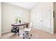 A home office with a desk, chair, and storage is well lit by a window at 4201 Village Green Dr, Roswell, GA 30075