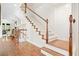 Elegant staircase with white railings and wood floors leads to the upper level at 4201 Village Green Dr, Roswell, GA 30075