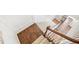 A staircase has carpeted steps and dark wood flooring on the landing at 4201 Village Green Dr, Roswell, GA 30075