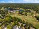 Aerial view of a luxurious golf course community, surrounded by lush greenery and a lake at 1059 Abington Ct, Brookhaven, GA 30319