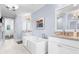 Bright bathroom featuring a modern soaking tub, elegant fixtures, and stylish decor at 1059 Abington Ct, Brookhaven, GA 30319
