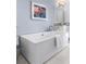 Bright bathroom featuring a modern soaking tub, elegant fixtures, and stylish decor at 1059 Abington Ct, Brookhaven, GA 30319