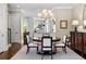 Open-concept dining area with hardwood floors and modern chandelier at 1059 Abington Ct, Brookhaven, GA 30319