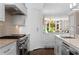 Contemporary kitchen with stainless steel appliances, range hood, and white subway tile at 1059 Abington Ct, Brookhaven, GA 30319