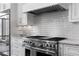 Modern kitchen showcasing stainless steel oven and cooktop with white tile backsplash at 1059 Abington Ct, Brookhaven, GA 30319