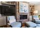 Cozy living room featuring a brick fireplace with custom built-ins, a large TV, and comfortable seating at 1059 Abington Ct, Brookhaven, GA 30319