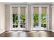 Living room with hardwood floors and lots of natural light from the French doors at 1059 Abington Ct, Brookhaven, GA 30319