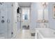 A well lit ensuite bathroom featuring a standing shower, vanity and soaking tub at 1059 Abington Ct, Brookhaven, GA 30319