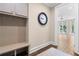 Mudroom with built-in bench, cabinets, coat hooks, and a view to the patio at 1059 Abington Ct, Brookhaven, GA 30319