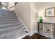 Elegant staircase with patterned carpet runner and stylish console table with decorative lamp at 1059 Abington Ct, Brookhaven, GA 30319
