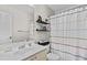 Bathroom features a vanity sink with a large mirror and striped curtain for bathtub at 1325 Richland Creek Ct, Sugar Hill, GA 30518