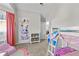 Bedroom featuring bunk beds, pink sofa, and large window with long pink curtains at 1325 Richland Creek Ct, Sugar Hill, GA 30518
