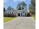 Charming single-Gathering home with well-manicured lawn, long driveway, and inviting curb appeal at 1325 Richland Creek Ct, Sugar Hill, GA 30518
