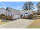 Inviting single-story home featuring manicured landscaping, a two-car garage, and classic design at 1325 Richland Creek Ct, Sugar Hill, GA 30518