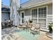 Outdoor patio area with dining furniture, lounge chairs, and landscaped borders at 1325 Richland Creek Ct, Sugar Hill, GA 30518