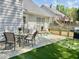 Patio features table, chairs, lounge chairs, landscaping and a barbeque grill at 1325 Richland Creek Ct, Sugar Hill, GA 30518