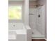Bathroom featuring a separate tub and shower at 1444 Bridgewater Br, Stone Mountain, GA 30088