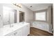 Bathroom with double sinks, a large soaking tub, and updated vanity at 1444 Bridgewater Br, Stone Mountain, GA 30088