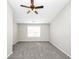 Large bedroom featuring a window, neutral paint, and soft grey carpet at 1444 Bridgewater Br, Stone Mountain, GA 30088