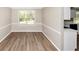 Sunny dining room with wood flooring, and a large window letting in natural light at 1444 Bridgewater Br, Stone Mountain, GA 30088