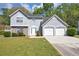 Charming two-story home with a two-car garage and manicured lawn at 1444 Bridgewater Br, Stone Mountain, GA 30088