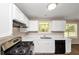 Bright kitchen featuring white cabinets, and modern appliances at 1444 Bridgewater Br, Stone Mountain, GA 30088