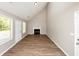 Open living room with vaulted ceiling, fireplace, and lots of natural light at 1444 Bridgewater Br, Stone Mountain, GA 30088