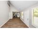 Open living area with hardwood floors and a view into the modern kitchen at 1444 Bridgewater Br, Stone Mountain, GA 30088