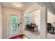 Inviting foyer flows into a dining area with a chandelier and natural light from large windows at 4719 Score Ct, Snellville, GA 30039