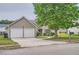 Charming one-story home featuring a two-car garage, well-maintained lawn, and mature tree at 4719 Score Ct, Snellville, GA 30039
