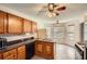 Classic kitchen with wooden cabinets, tiled floors, and a stainless-steel refrigerator next to the gas range at 4719 Score Ct, Snellville, GA 30039