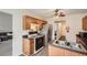 Cozy kitchen with stainless steel appliances, oak cabinets, and tiled floors leading into another room at 4719 Score Ct, Snellville, GA 30039