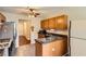 Functional kitchen with stainless steel appliances, tiled floor, and wooden cabinetry with a view of the hallway at 4719 Score Ct, Snellville, GA 30039