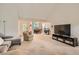 Bright living room featuring plush carpeting, neutral tones, and an open layout flowing into the dining area and front entrance at 4719 Score Ct, Snellville, GA 30039