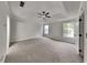 Expansive primary bedroom featuring a tray ceiling and abundant natural light at 132 Garden Manor Ct, Loganville, GA 30052